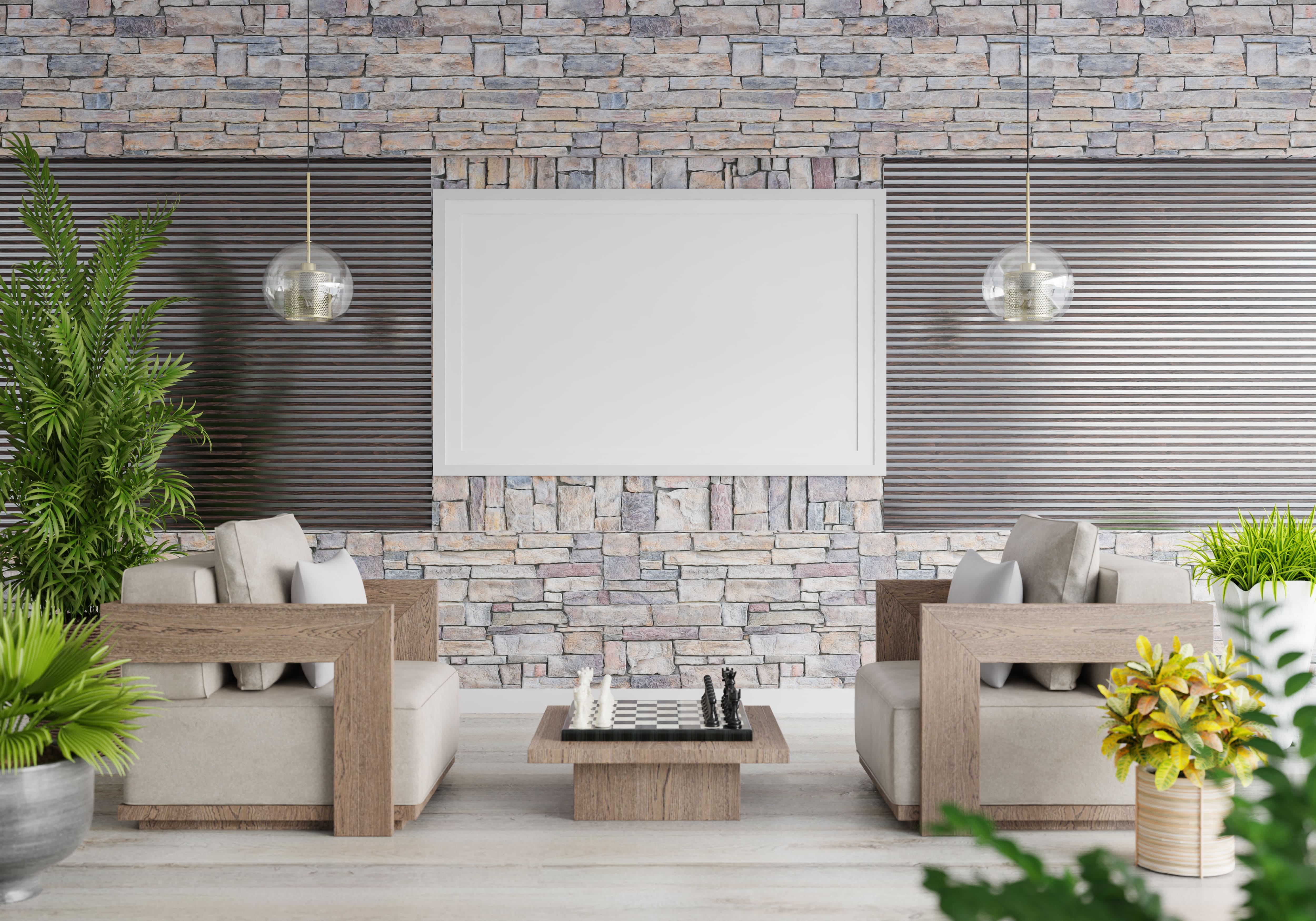 interior de una moderna cocina americana con techos altos Interior de una sala con unos sofas, una mesita y un muro de piedra artificial al fondo